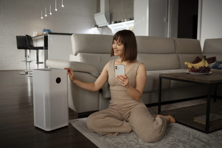 young woman using home technology TheHomeQuality